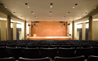 Proshansky Auditorium - Auditorium Rental in NYC. View from the back of the auditorium - stage and seating.