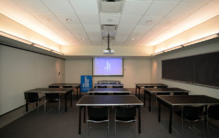 9th Floor Conference Room Suite - Meeting Space in NYC. Room set up for class or presentation with desks.