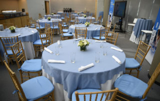 Kelly Skylight Room - Flexible Event Space in NYC. Table setting for corporate dinner, overlooking The Graduate Center's Dining Commons.