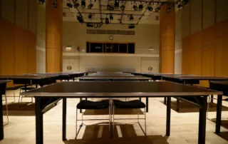 Segal Theatre - Black Box Theater Rental in NYC. Set up classroom style, looking towards back of the theater space.